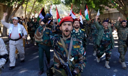 Houthi fighters march in solidarity with Palestinians in Yemen.