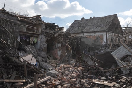 Residents remove debris from their home