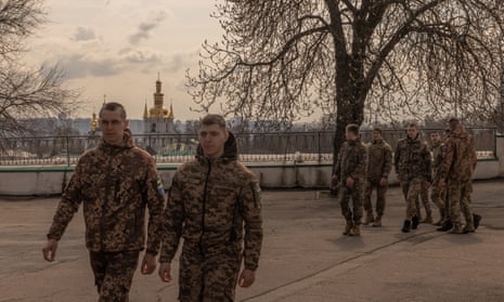 Ukrainian soldiers walk in the Kyiv-Pechersk Lavra compound after attending the Palm Sunday service by Metropolitan Epiphanius of the Orthodox Church of Ukraine.