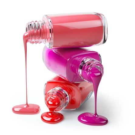 Three open bottles of nail varnish – coral, pink and red – lying on their side and on top of each other, with the varnish inside dripping out of them