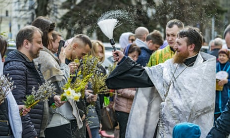 A priest from St Volodymyr's Cathedral blesses the public with holy water on Orthodox Palm Sunday in Kyiv.