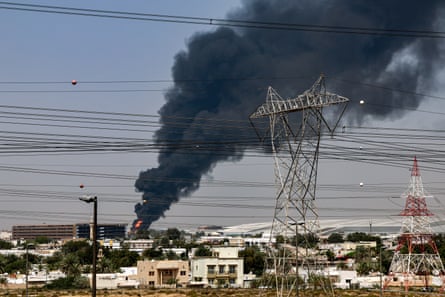 A smoke plume rises over Dubai international airport