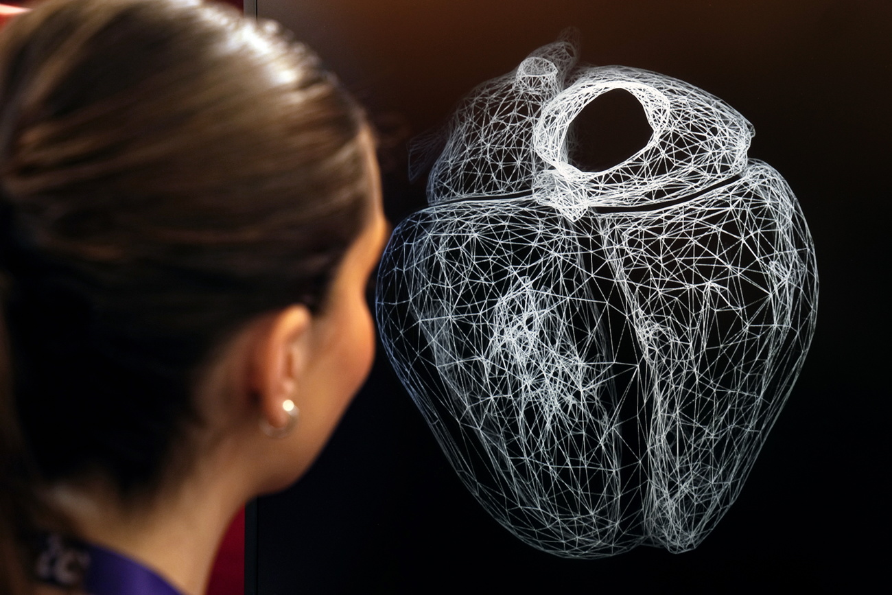A visitor looks at a virtual version of her heart at the Mobile World Congress in Barcelona 2024.