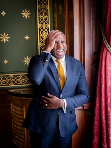Portrait of David Lammy in a formal setting laughing
