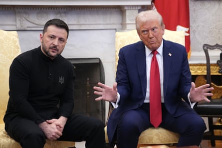 a man with a stern expression sits with his hands clasped while another man talks at him with his hands outstretched