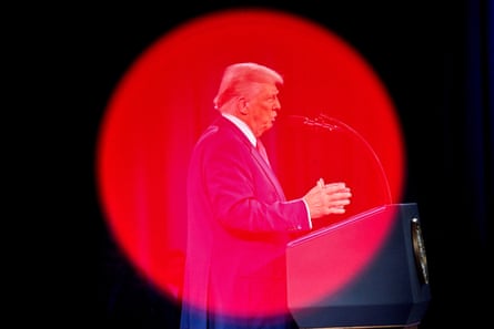 man in a suit speaks into a microphone