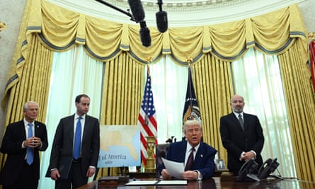 four men in suits in the oval office