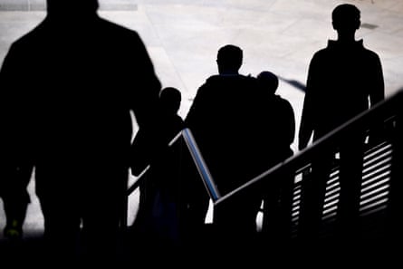 silhouettes of men walking down a stairway
