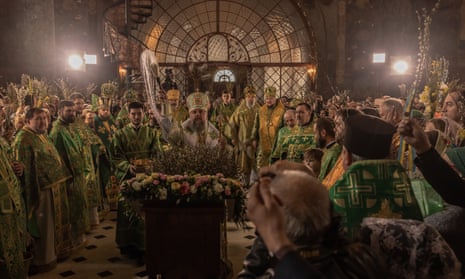 Metropolitan Epiphanius of the Orthodox Church of Ukraine blesses believers holding willow branches during the Palm Sunday service in the Refectory Church of the Kyiv-Pechersk Lavra.