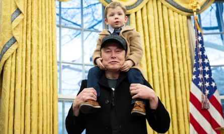 a man with a black baseball cap has a boy on his shoulders