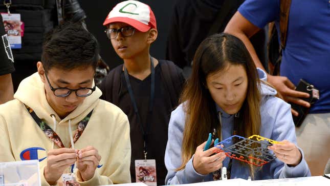 A photo shows attendees at Anime Expo 2019 building gunplas.