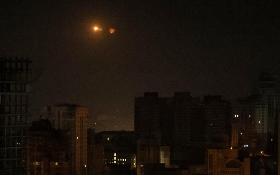 An explosion of a drone is seen in the sky over the city of Kyiv during a Russian drone strike - GLEB GARANICH/REUTERS