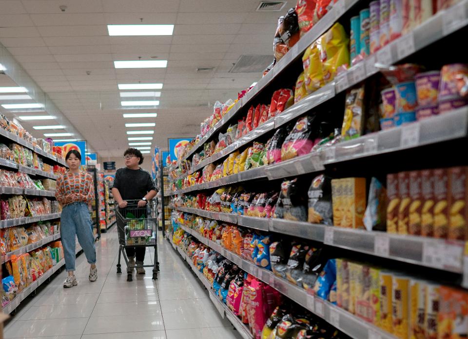 People are shopping snacks in a supermarket. The National...