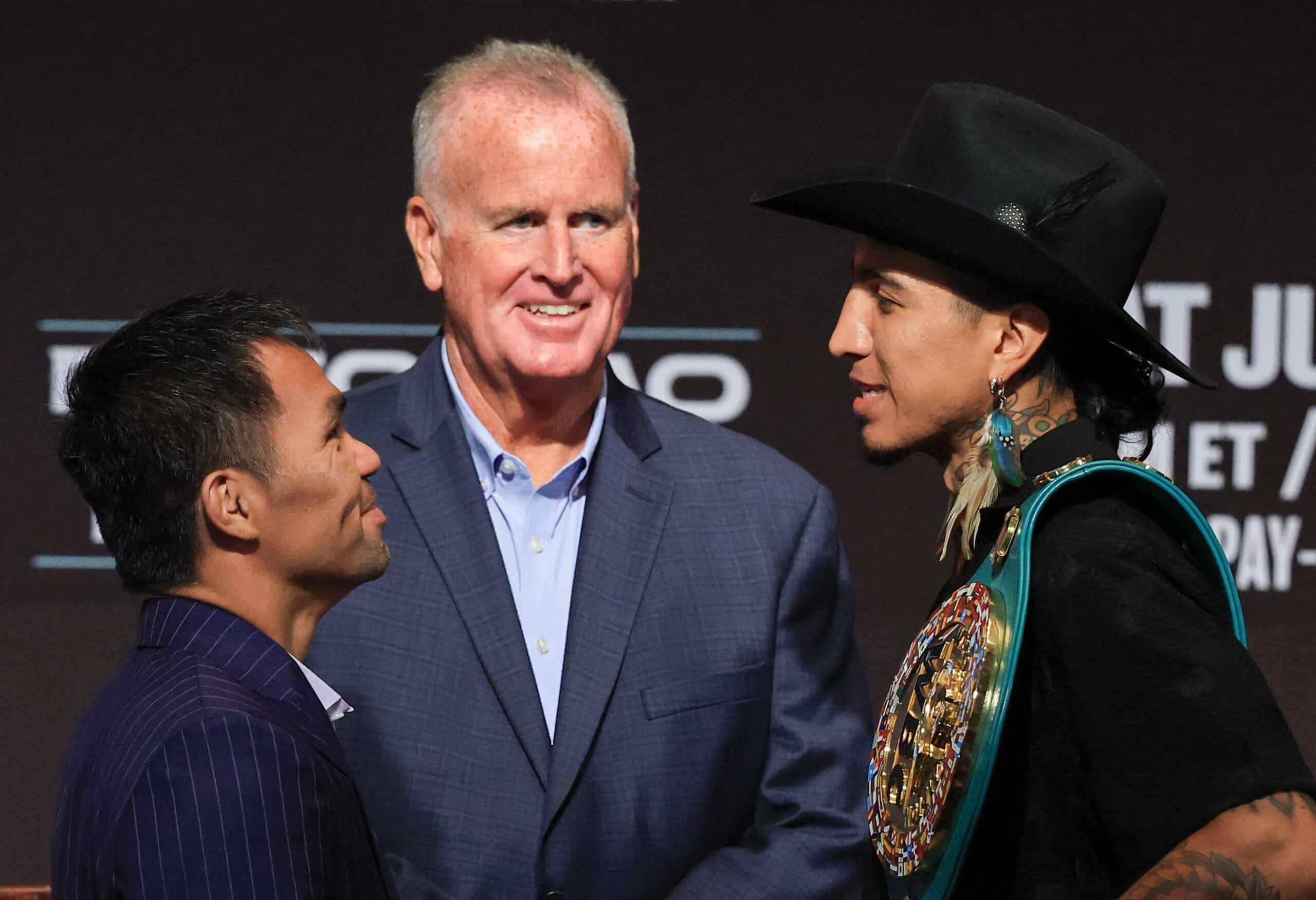 TGB Promotions President Tom Brown (C) looks on as Manny Pacquiao (L) and WBC welterweight champion Mario Barrios (R) face off during their news conference at MGM Grand Hotel & Casino on July 16, 2025 in Las Vegas, Nevada.