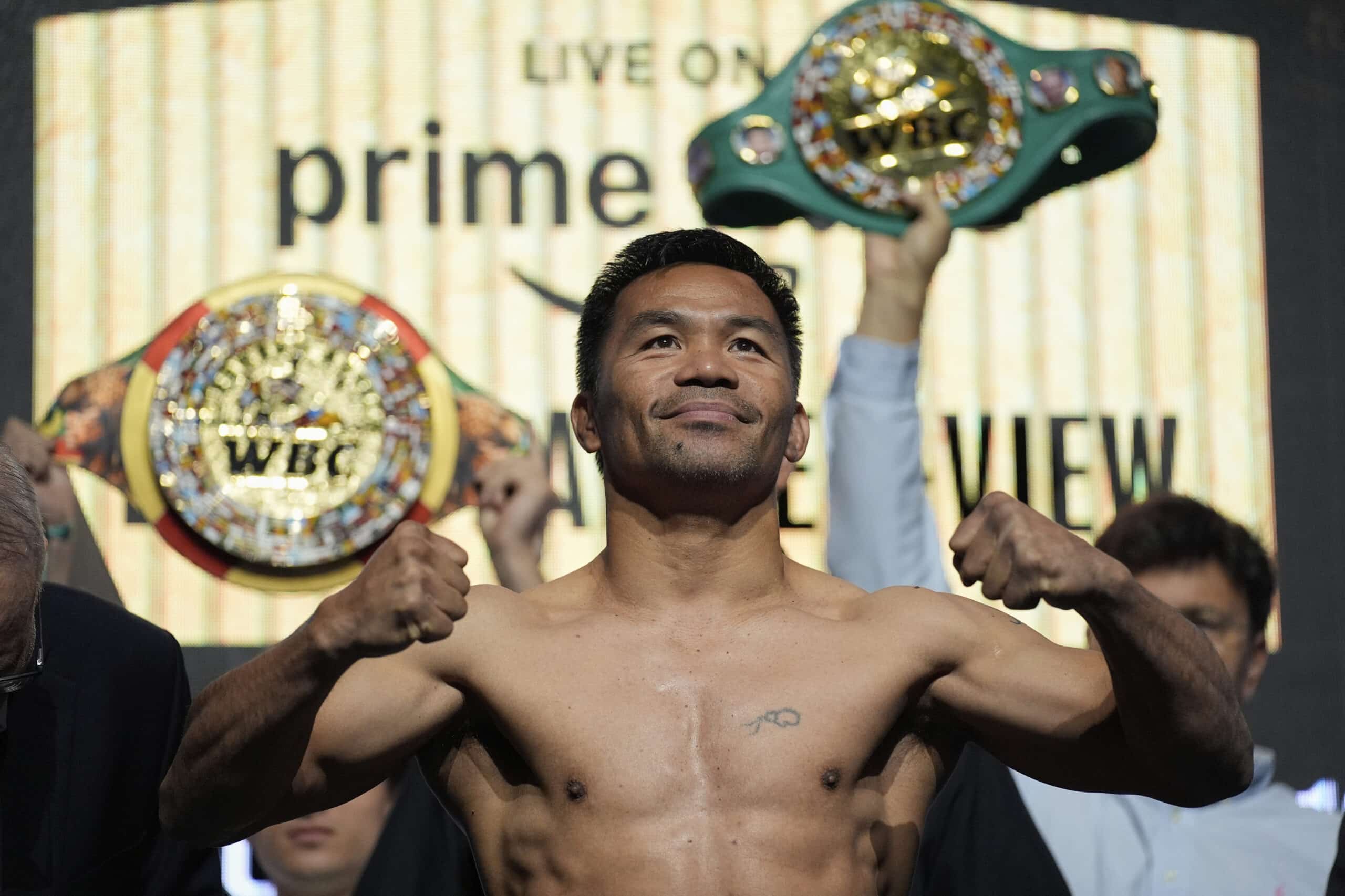 Manny Pacquiao poses on the scale during a ceremonial weigh in Friday, July 18, 2025, in Las Vegas.