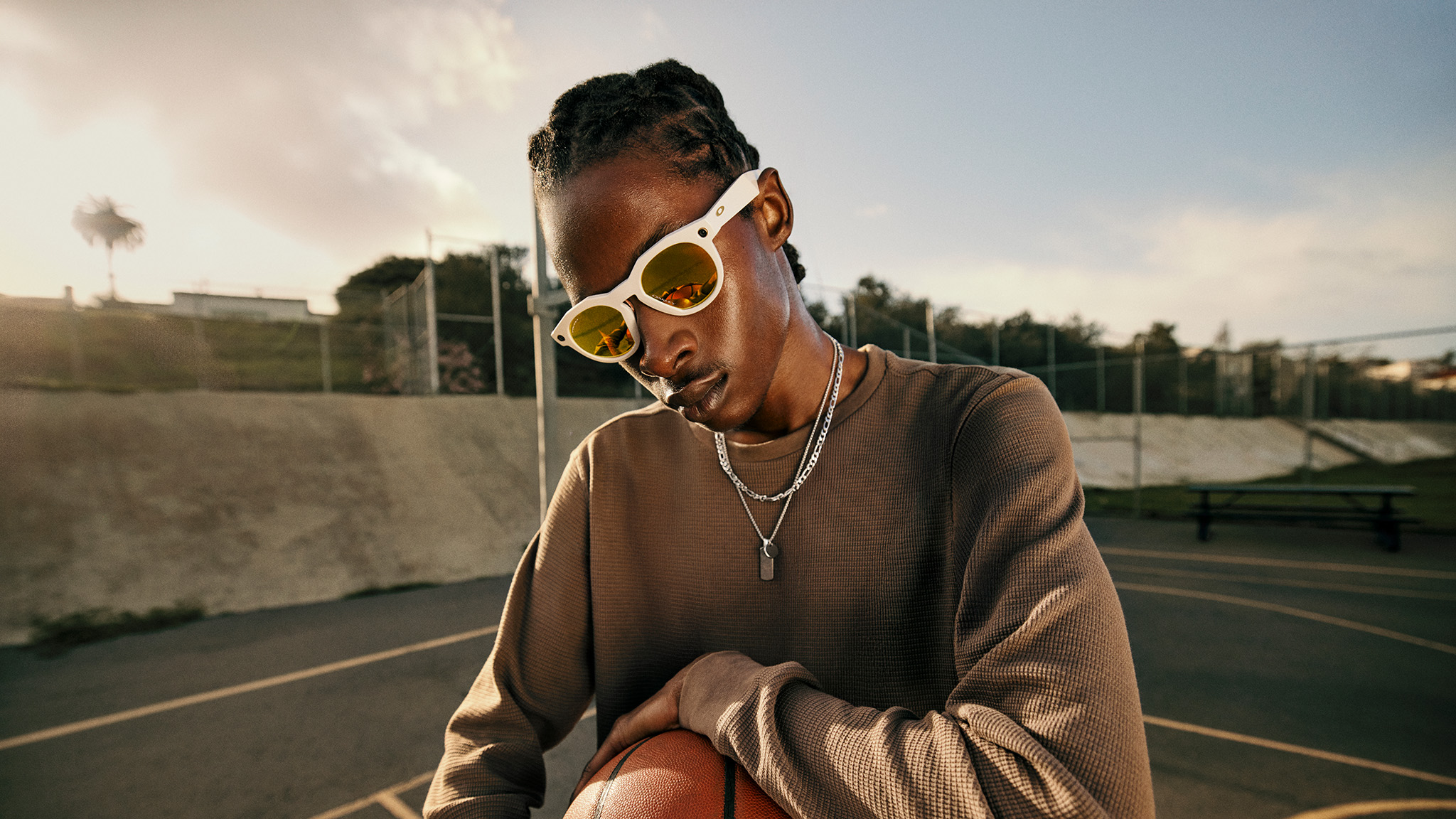 Official lifestyle shots of a person wearing Oakley Meta HSTN smart glasses