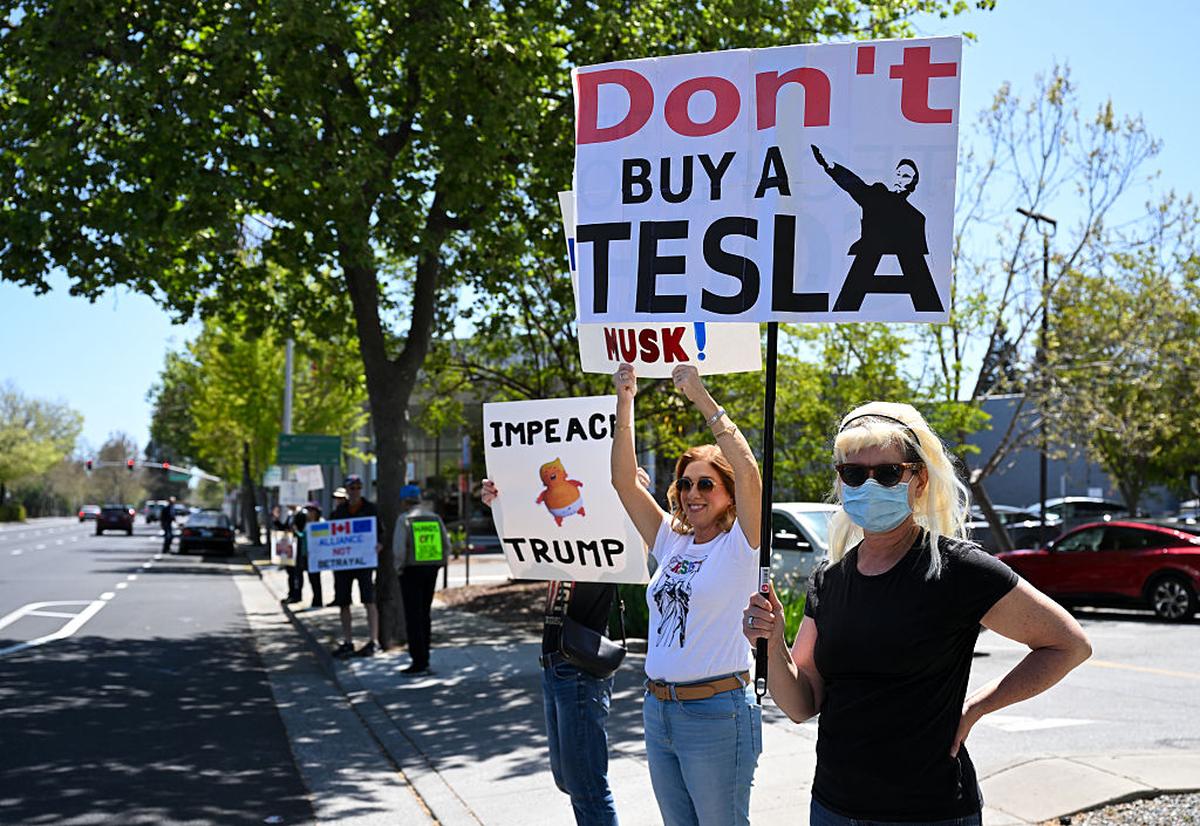 Protesters outside a Tesla dealership in Palo Alto, California, April 12, 2025. 