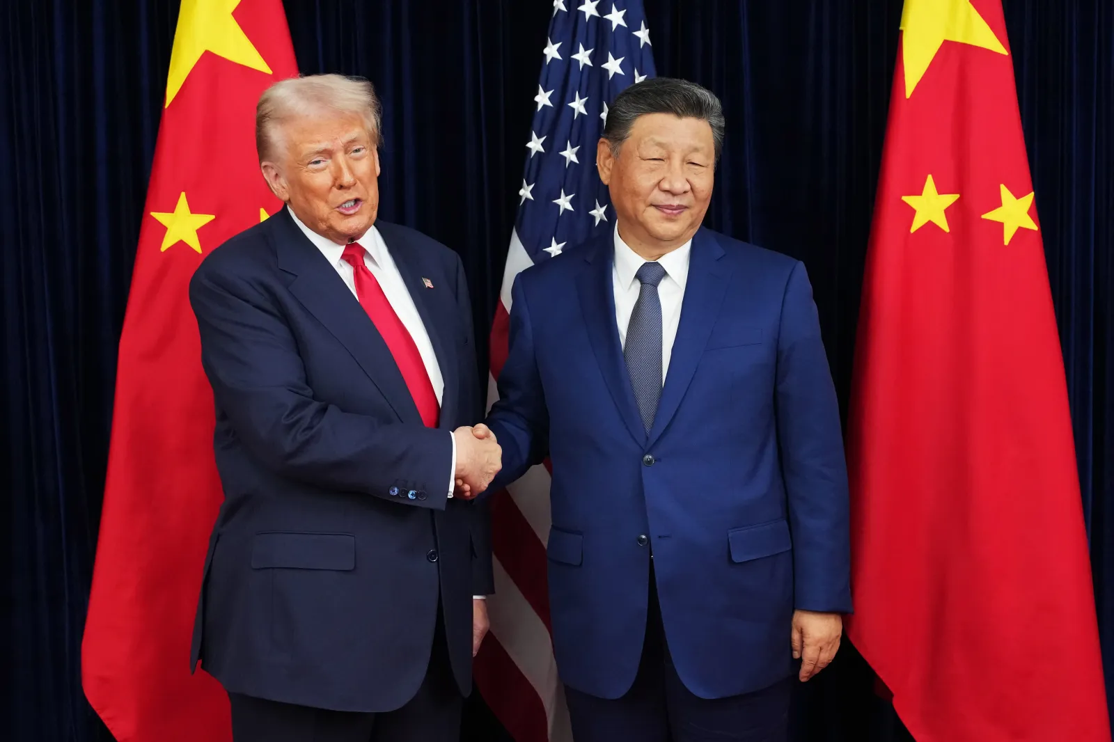 U.S. President Donald Trump greets Chinese President Xi Jinping ahead of their latest bilateral meeting at Gimhae Air Base on October 30, 2025, in Busan, South Korea.