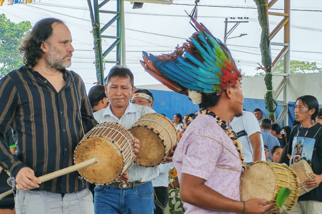 Andrés Tapia (left) marches and drums with his community during a ceremony commemorating new leadership of the grassroots organization San Jacinto del Pindo Commune. Credit: Courtesy of Andrés Tapia