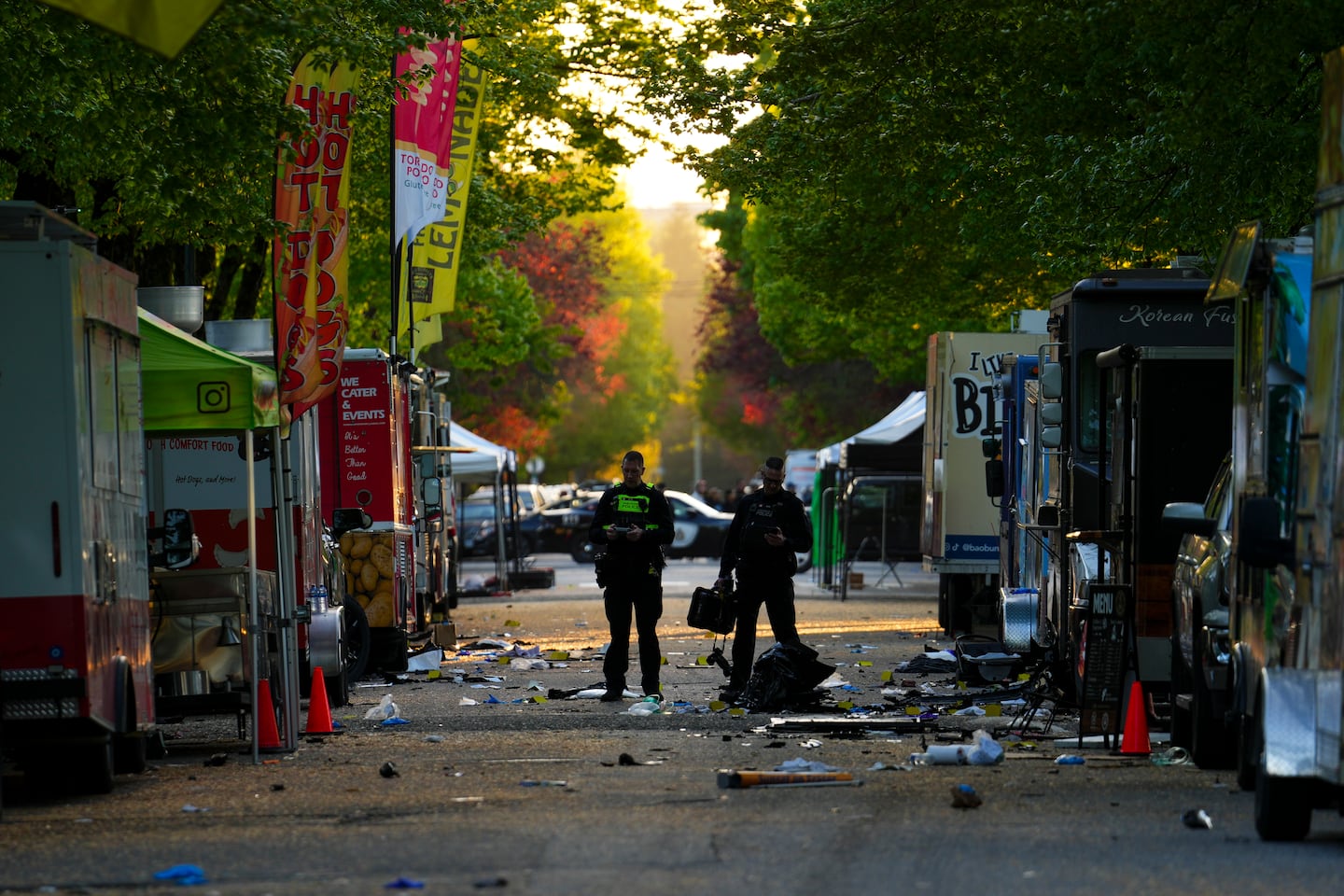 Members of the Vancouver Police forensics team examines the scene where a vehicle drove into a crowd during a Filipino heritage festival in Vancouver.