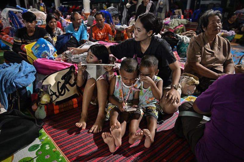Evacuees displaced by the ongoing conflict between Thailand and Cambodia rest at an evacuation centre in the Thai border province of Si Sa Ket.