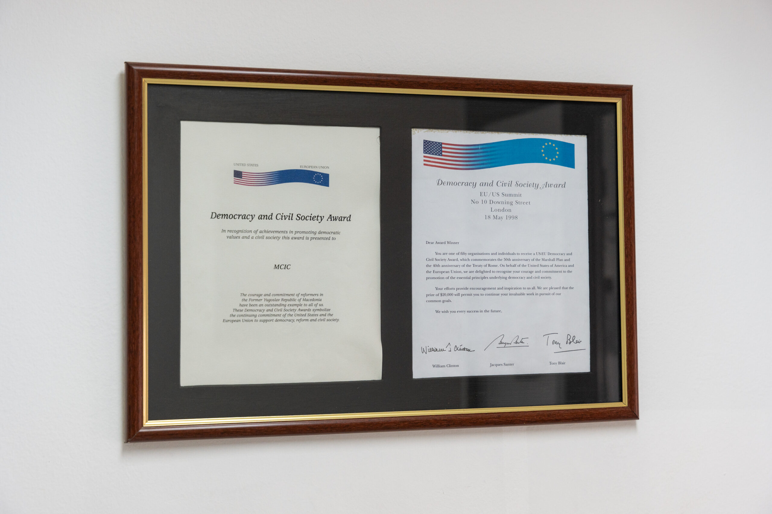 Two framed certificates on a wall