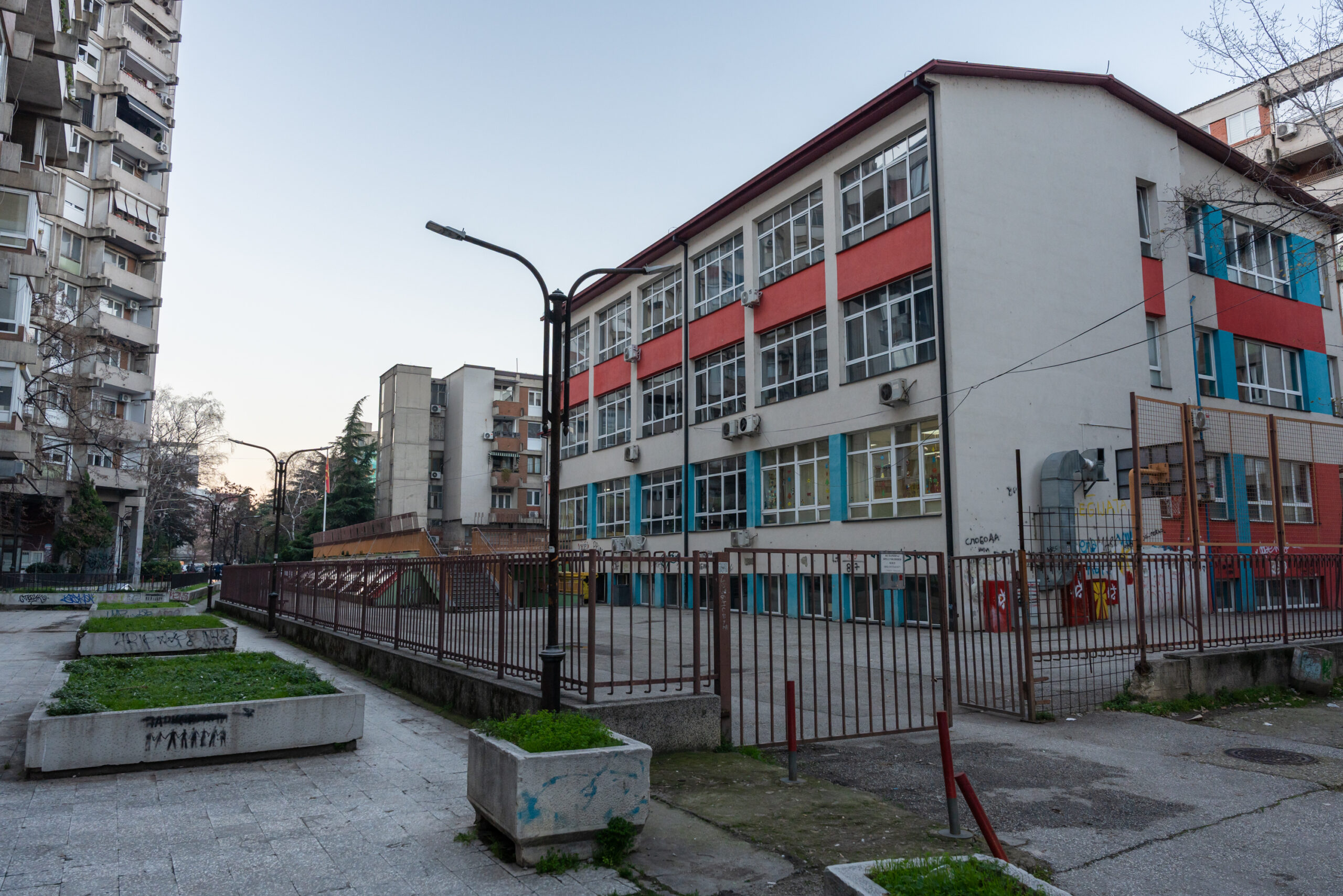 View of a school building with colourful façades, surrounded by residential buildings