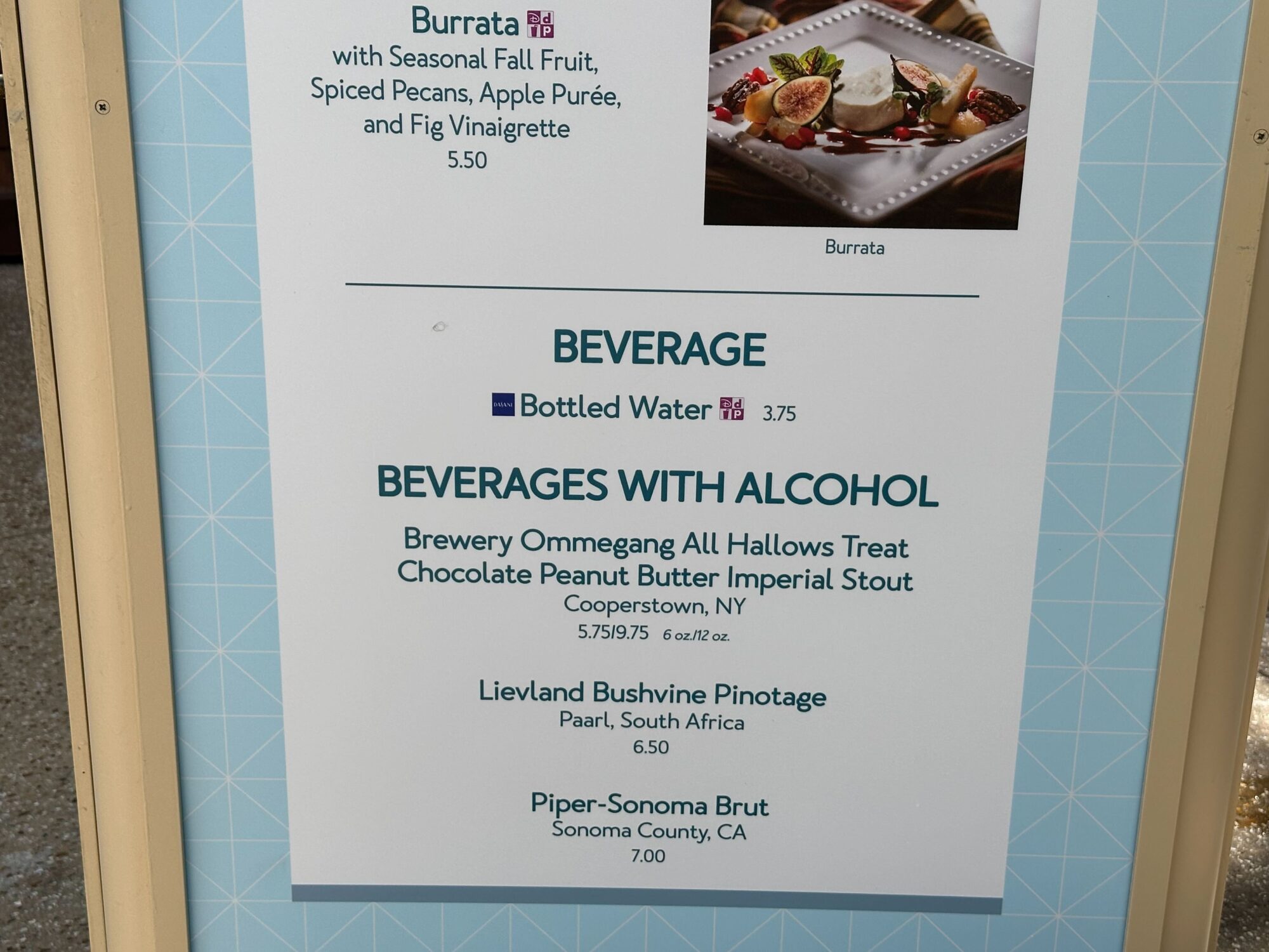 Menus (With Prices) for 2024 EPCOT International Food & Wine Festival 66 A menu displaying beverages, including bottled water and alcoholic options such as Brewery Ommegang All Hallows Treat, Lievland Bushvine Pinotage, and Piper-Sonoma Brut, perfect for a food & wine festival.
