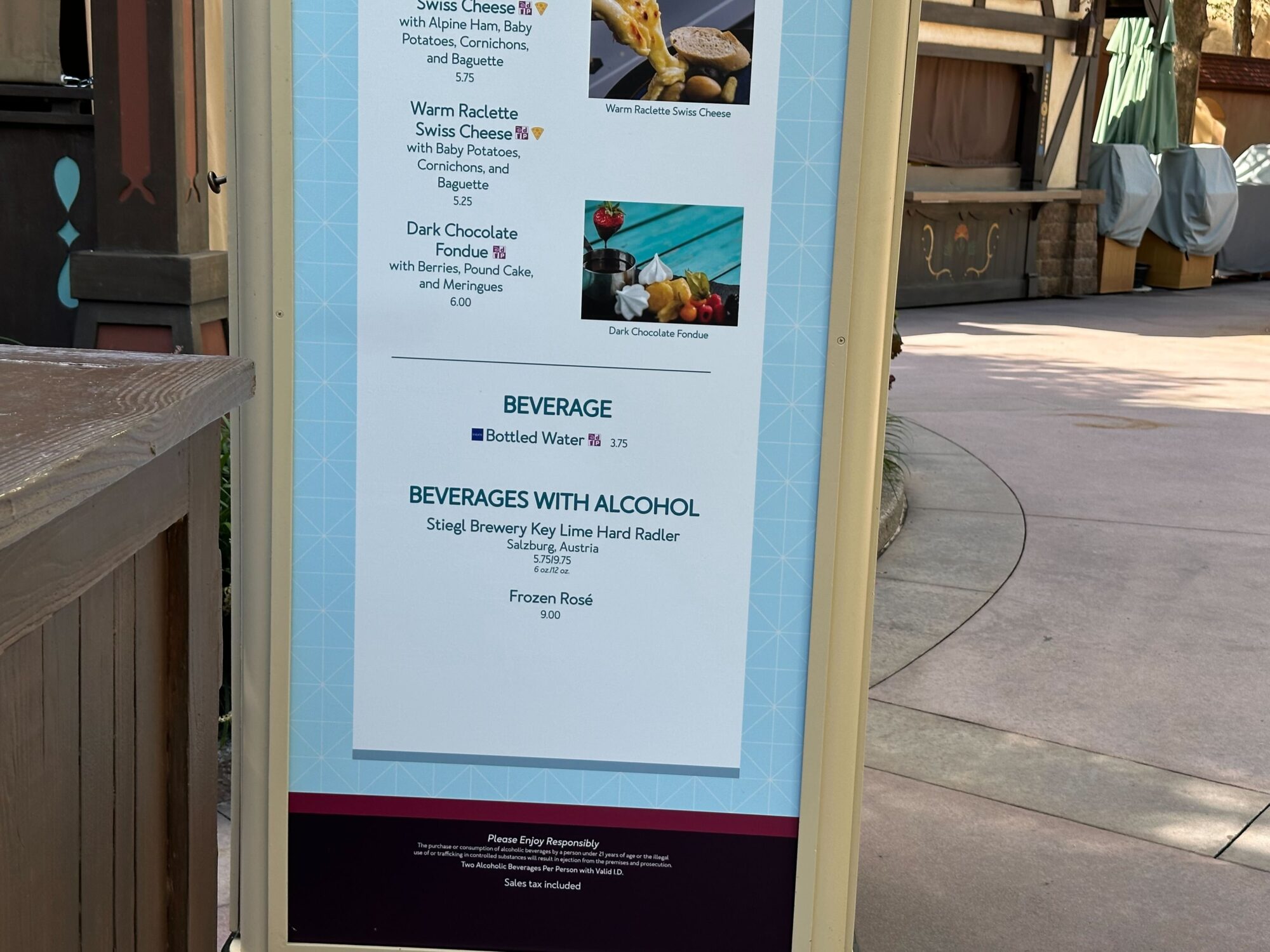 Menus (With Prices) for 2024 EPCOT International Food & Wine Festival 30 A menu board displays food and beverage options including cheese dishes, chocolate fondue, bottled water, Key Lime Hard Radler, and Frozen Rosé.