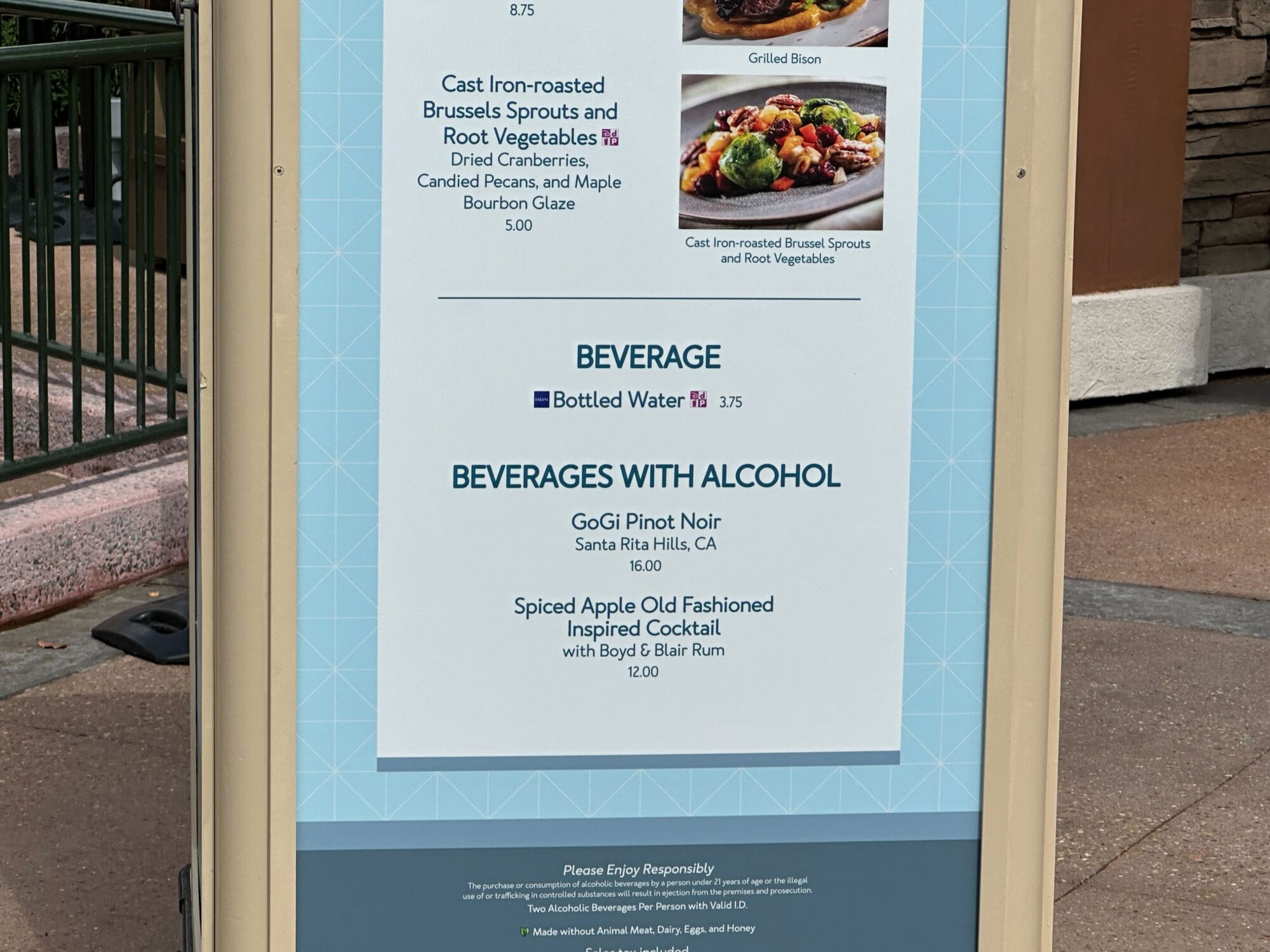 Menus (With Prices) for 2024 EPCOT International Food & Wine Festival 72 Menu board showcasing delectable options for the food & wine festival, including Cast Iron-roasted Brussel Sprouts, Grilled Bison, Goggi Pinot Noir wine, and a Spiced Apple Old Fashioned cocktail.