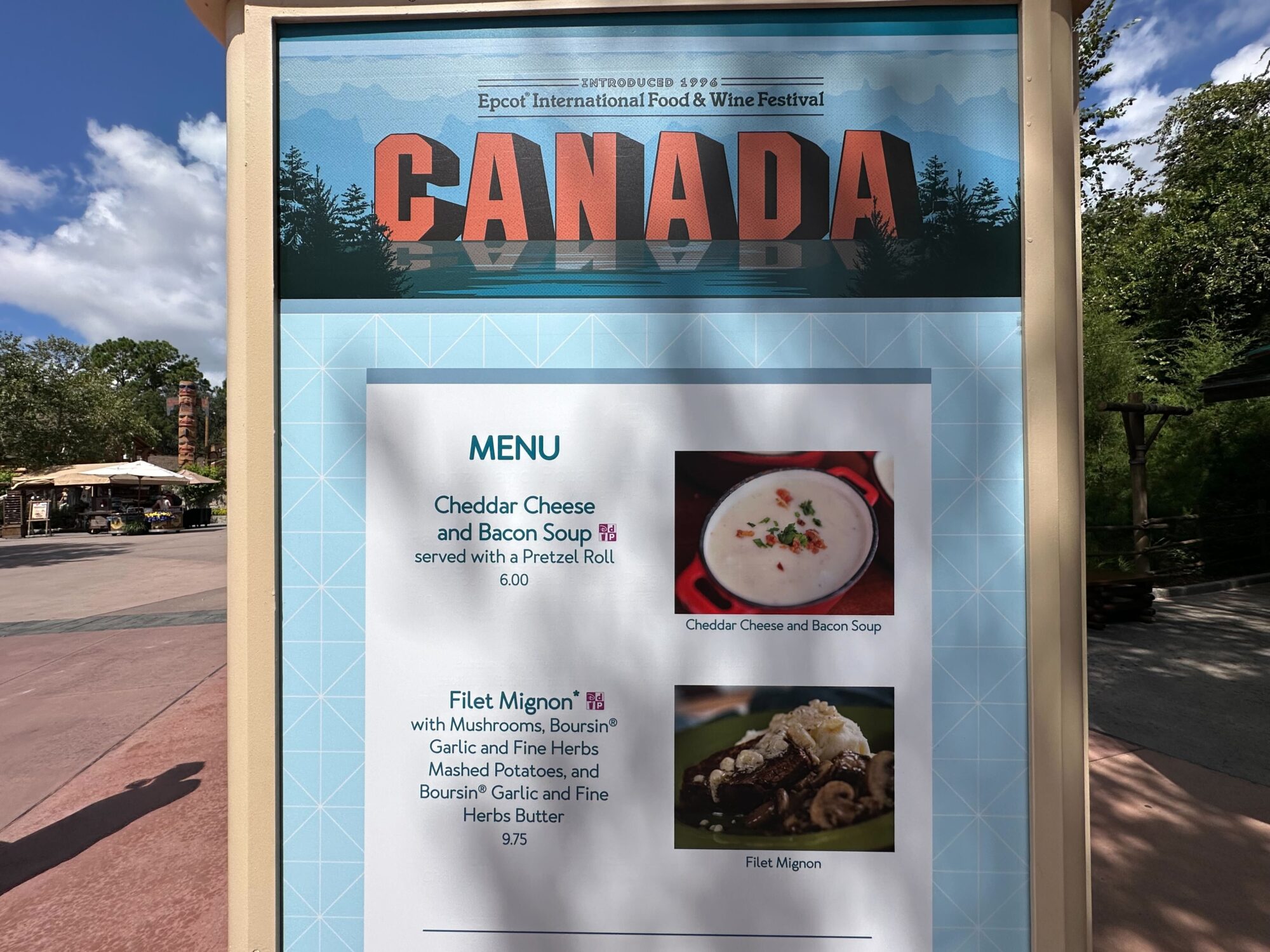 Menus (With Prices) for 2024 EPCOT International Food & Wine Festival 57 A sign for the Canada section at the Epcot International Food & Wine Festival, displaying menus with Cheddar Cheese and Bacon Soup for $6.00 and Filet Mignon for $9.75.