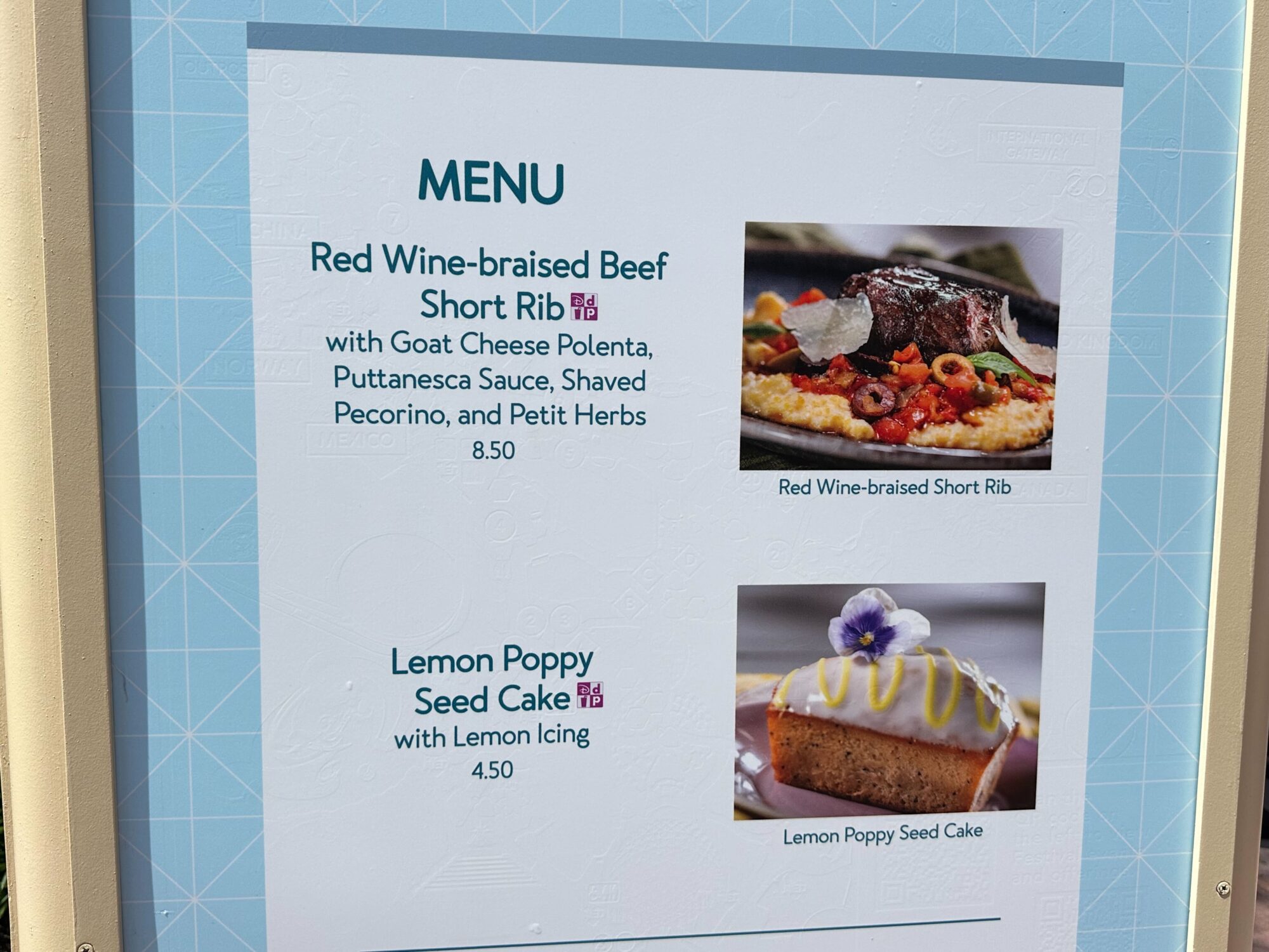 Menus (With Prices) for 2024 EPCOT International Food & Wine Festival 74 Close-up of a menu at the food & wine festival featuring Red Wine-braised Beef Short Rib with Goat Cheese Polenta for $8.50, and Lemon Poppy Seed Cake with Lemon Icing for $4.50.