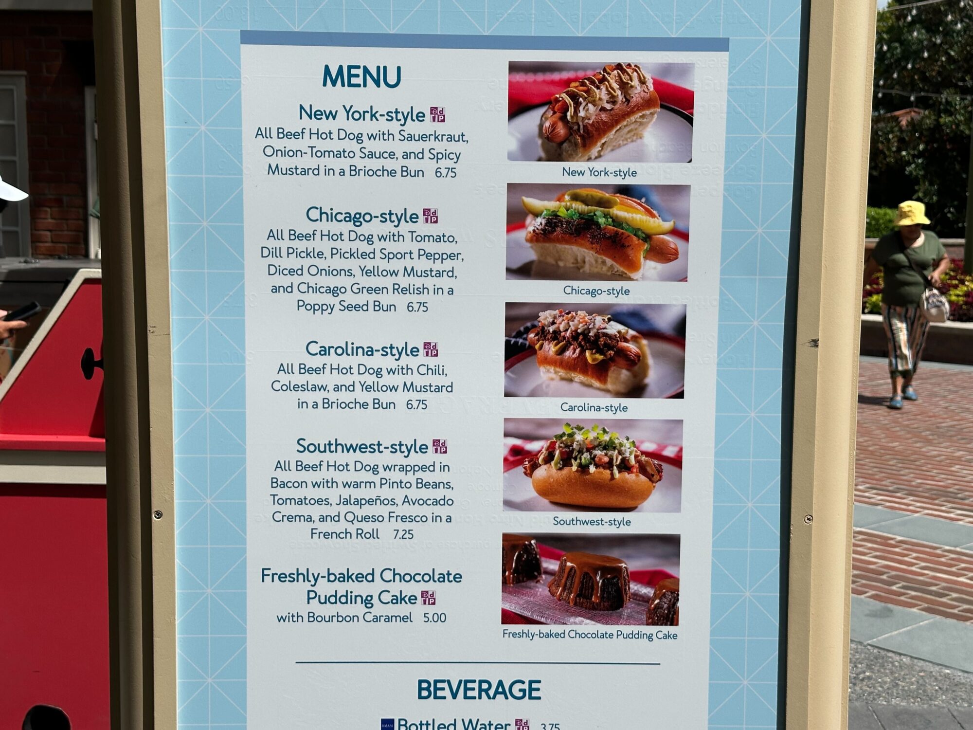 Menus (With Prices) for 2024 EPCOT International Food & Wine Festival 41 A menu board showcasing different styles of hot dogs: New York-style, Chicago-style, Carolina-style, Southwest-style, Freshly-baked Chocolate Pudding Cake, and beverage options is perfect for any food & wine festival.