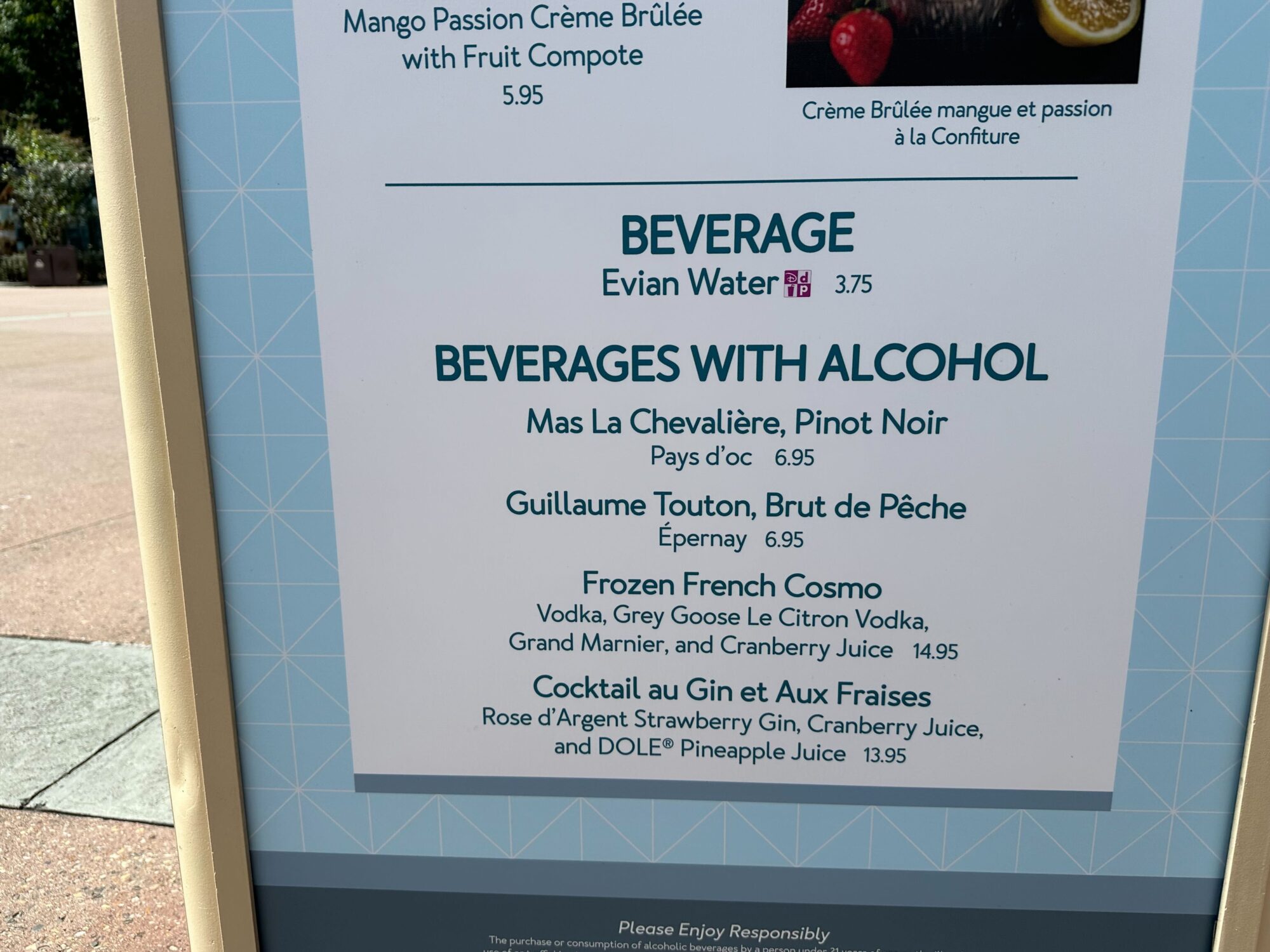 Menus (With Prices) for 2024 EPCOT International Food & Wine Festival 55 A menu at the food & wine festival showcases a delightful selection of beverages, including Evian water and an array of alcoholic options like Pinot Noir, Brut de Pêche, Frozen French Cosmo, and Cocktail au Gin et Aux Fraises.