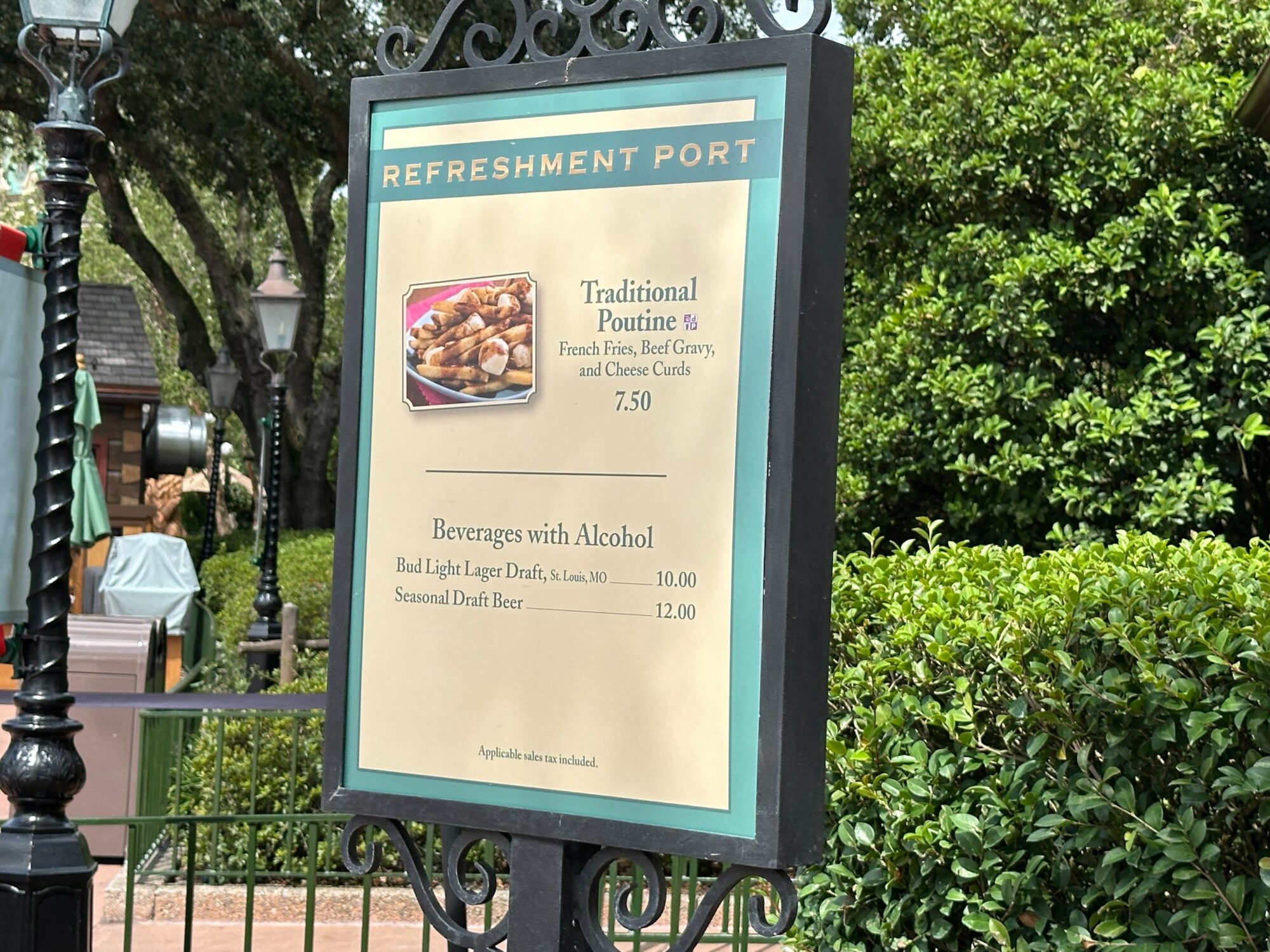 Menus (With Prices) for 2024 EPCOT International Food & Wine Festival 60 A sign at the Refreshment Port showing the menus, featuring items like Traditional Poutine for $7.50 and beverages with alcohol, such as Bud Light Lager Draft for $10.00 and Seasonal Draft Beer for $12.00, perfect for enjoying during the food & wine festival.