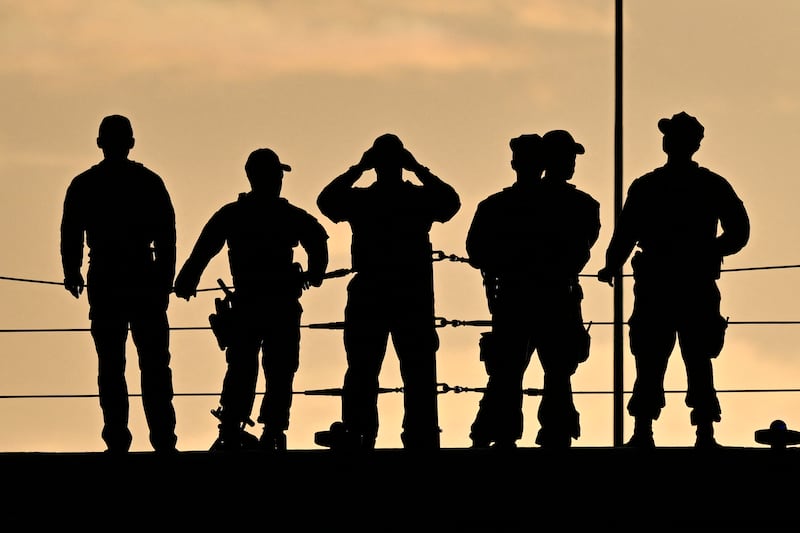 Military personel are seen on the assault ship USS Iwo Jima docked at Rafael Cordero Santiago Port of the America in Puerto Rico. Photograph: Miguel J. Rodriguez Carrillo/AFP/Getty Images