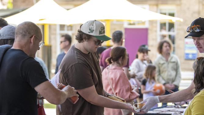 : Voters at the polling booth at Bourke St, Public School enjoy a sausage sizzle as they wait too vote in the NSW Local Government Election 2024. Picture: NewsWire / Simon Bullard