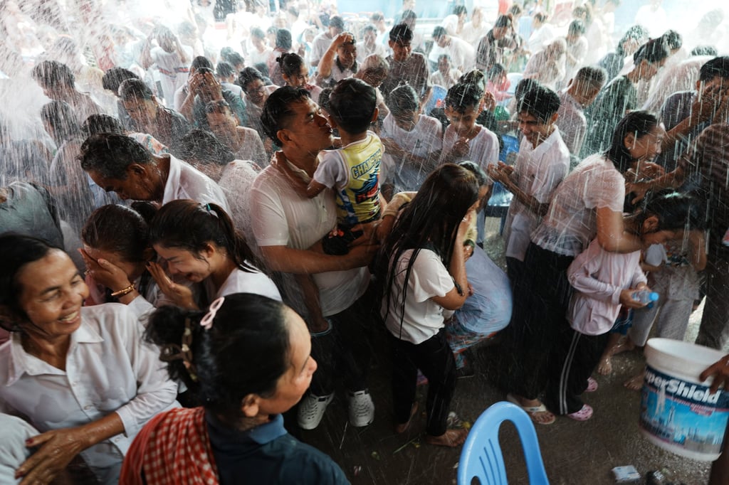 Residents of a village on the outskirts of Phnom Penh, Cambodia, receive a holy water shower believed to bring good luck during Choul Chnam Thmey celebrations on Sunday. Photo: AP Residents of a village on the outskirts of Phnom Penh, Cambodia, receive a holy water shower believed to bring good luck during Choul Chnam Thmey celebrations on Sunday. Photo: AP