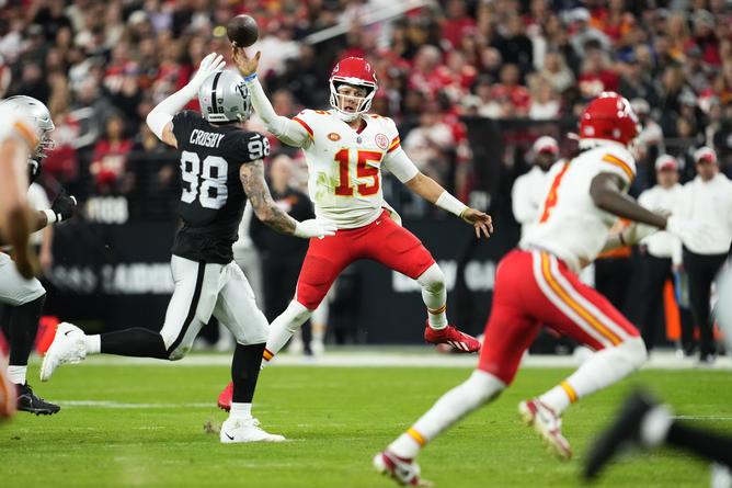 LAS VEGAS, NEVADA - NOVEMBER 26: Patrick Mahomes #15 of the Kansas City Chiefs throws a pass over Maxx Crosby #98 of the Las Vegas Raiders during the third quarter at Allegiant Stadium on November 26, 2023 in Las Vegas, Nevada. (Photo by Jeff Bottari/Getty Images) *BESTPIX*