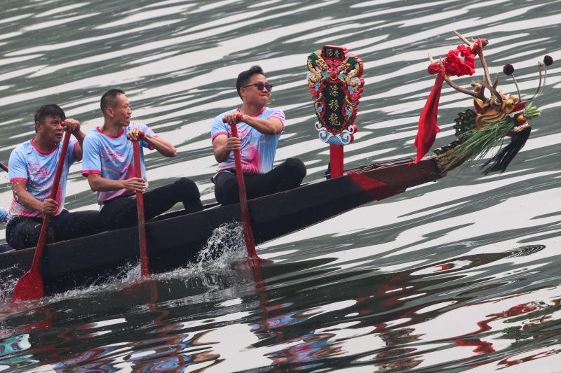 Participants row a traditional boat as they take part in a performance before the start of the races during Dragon Boat Festival celebrations in Beijing on Friday. (Photo: Reuters)