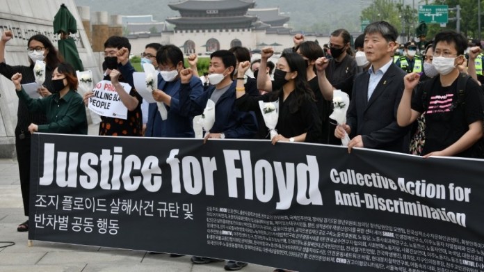 South Korean protesters shout slogans during an anti-racism rally over the death of George Floyd, a black man who died while in custody of the Minneapolis police, near the US embassy in Seoul on June 5, 2020. Jung Yeon-je / AFP South Korea Floyd