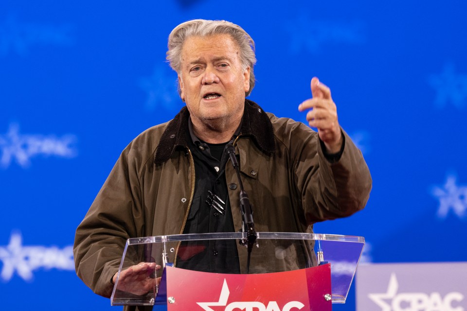 Steve Bannon speaking at a podium at the CPAC Conference.