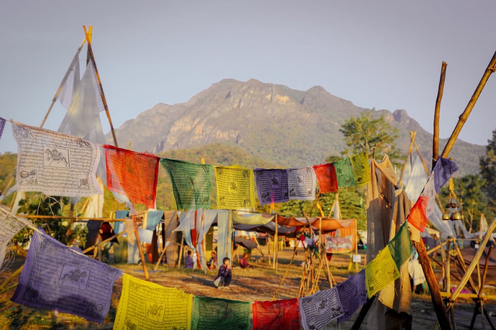 Shambhala campsite decorated with colourful flags, with Doi Chiang Dao in the background, Thailand. Photo: David Frazier Shambhala campsite decorated with colourful flags, with Doi Chiang Dao in the background, Thailand. Photo: David Frazier