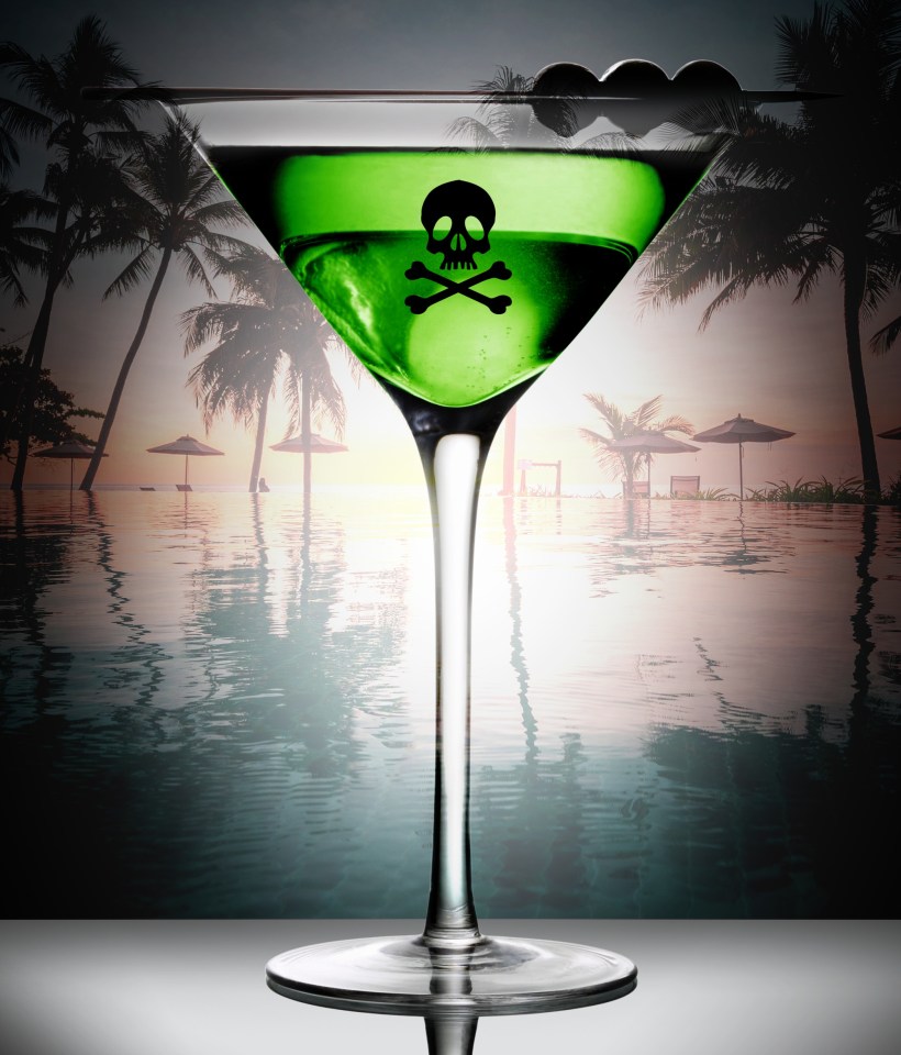 Martini glass with skull and crossbones in green liquid against a tropical beach background.