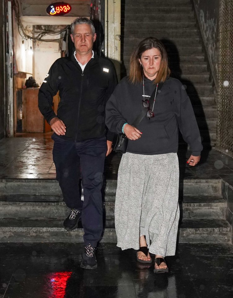 A man and woman walking down stairs.
