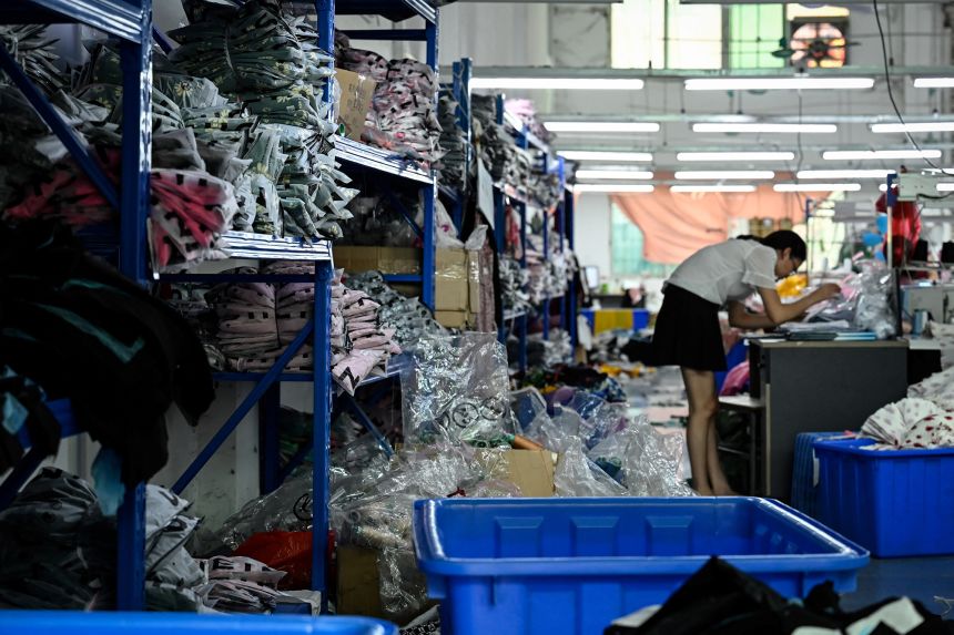 A worker makes clothes at a garment factory that supplies SHEIN, a cross-border fast fashion e-commerce company in Guangzhou, in China's southern Guangdong province on July 18, 2022.