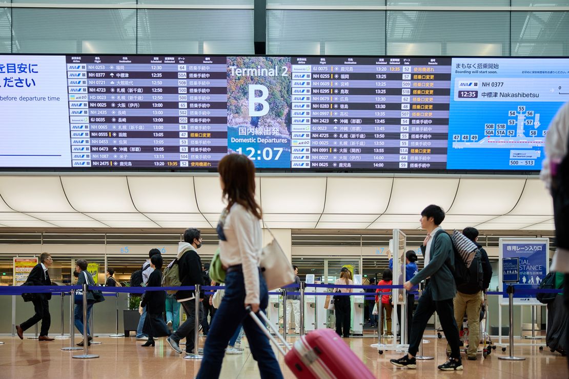 Travelers at Haneda Airport, one of Japan's busiest air traffic hubs.