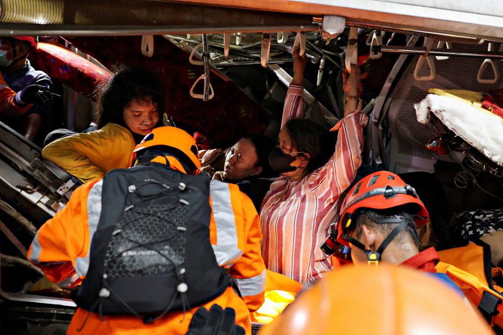 Victims trapped in the damaged train after two trains collided late on Monday in the city of Bekasi