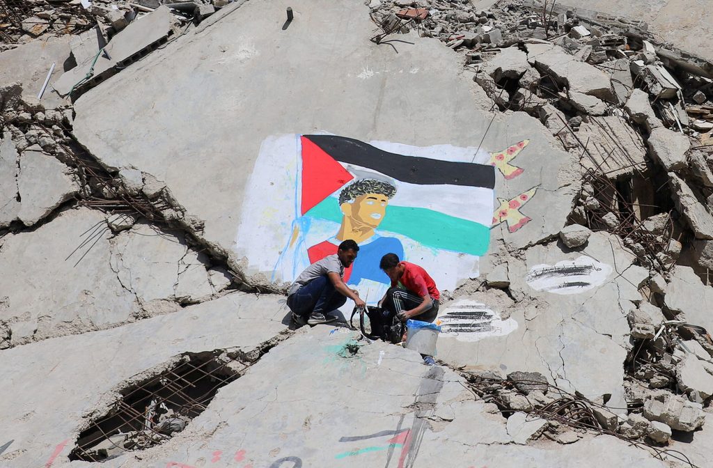 Palestinian artists paint a mural depicting soccer star Lamine Yamal, in Gaza City