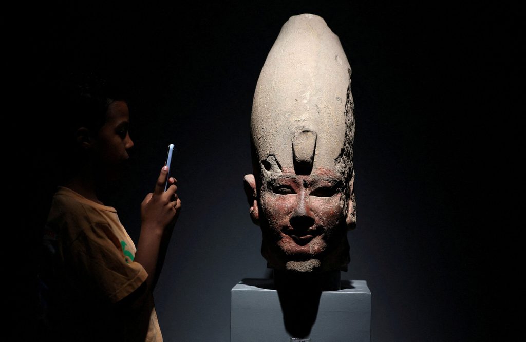 A boy takes picture inside the Luxor Museum, in Luxor